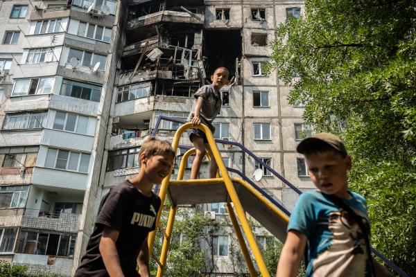 Image from Russian-Ukrainian War - Kids visiting the destroyed building at their...