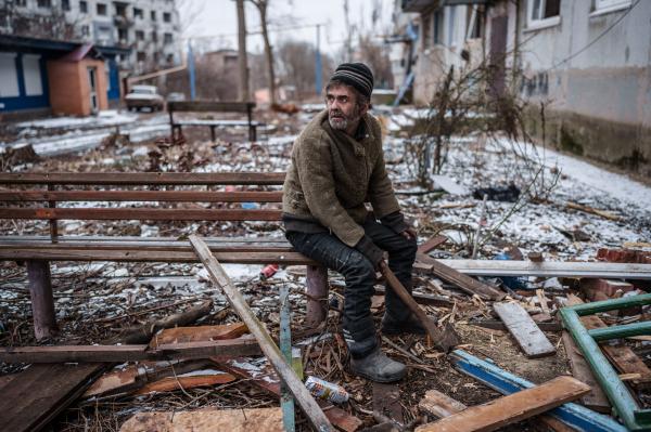 Image from The New Symphony of Donbas - Olexiy prepares wood for his stove in the frontline town...