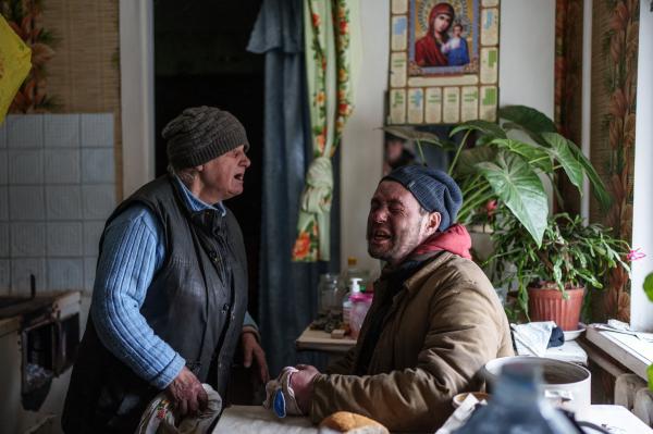 Image from The New Symphony of Donbas - Alla Baltuck, 80, calming her grandson Serhii, left, as...