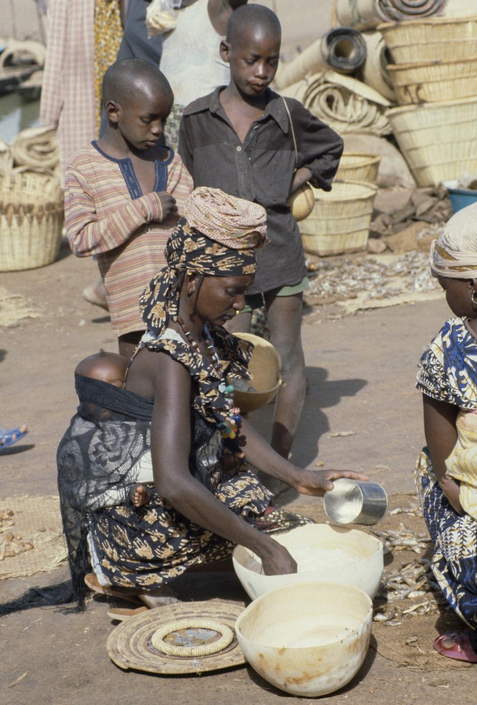 Getting milk at a market in Mopti, Mali.