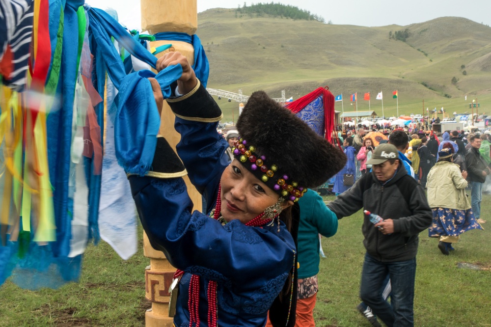 A Buryat woman ties up a blessi...s and positive spiritual ideas.