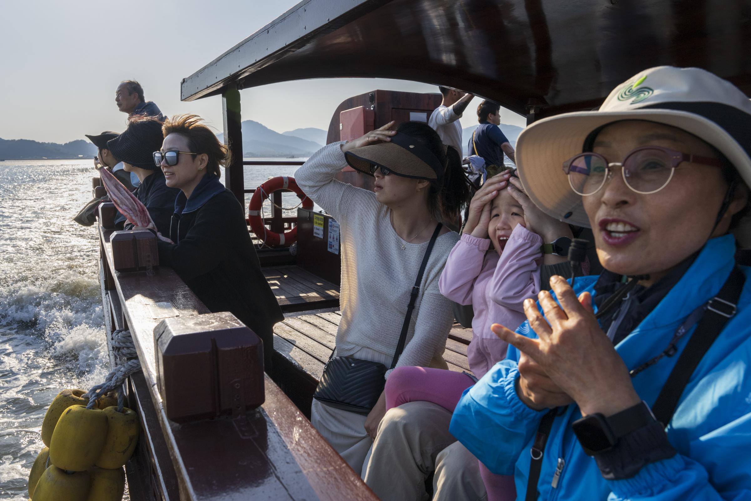 Saving South Korea's Tidal Flats -  Ecotourist guide Sunjeong Heo points out a flock of...