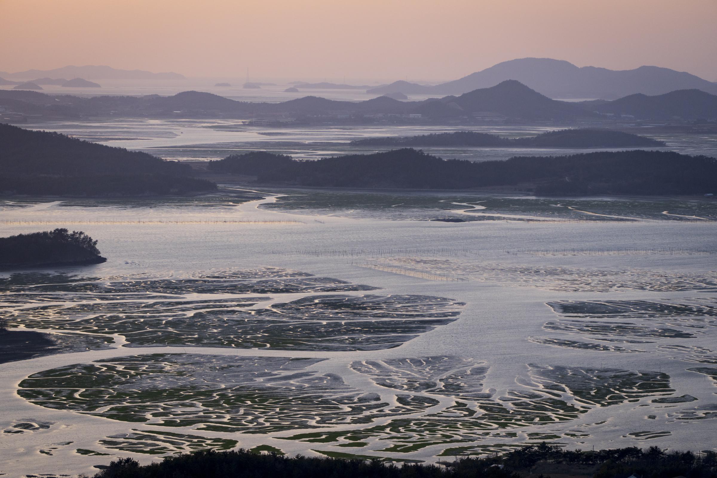 Saving South Korea's Tidal Flats - The sun sets over a tidal flat in southwestern South...