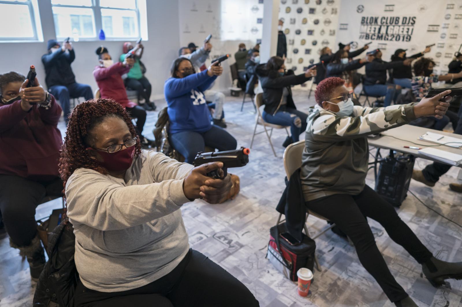 Students learn the basics of gu... of Black people with firearms.