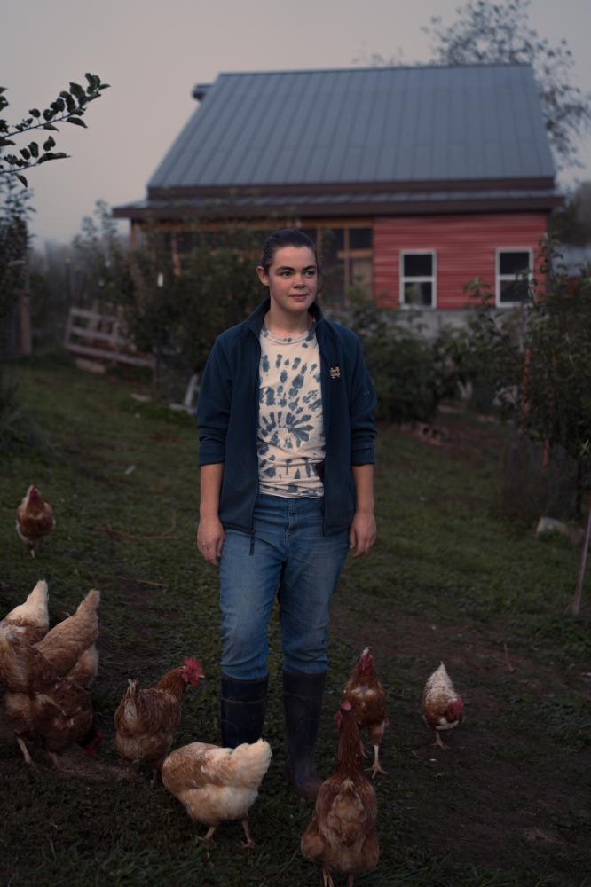 A Spirit of Abundance for Commonweal Magazine - Molly Sutter stands in the orchard with the chickens at dawn. Feeding them is her first duty for...