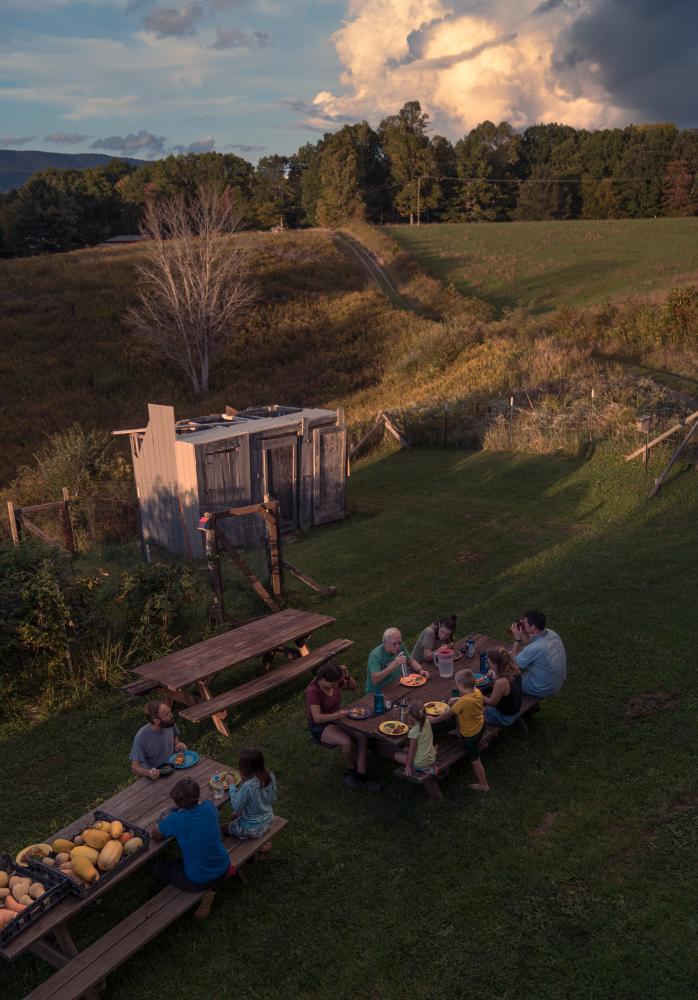 A Spirit of Abundance for Commonweal Magazine - The group shares dinner outdoors at sunset.