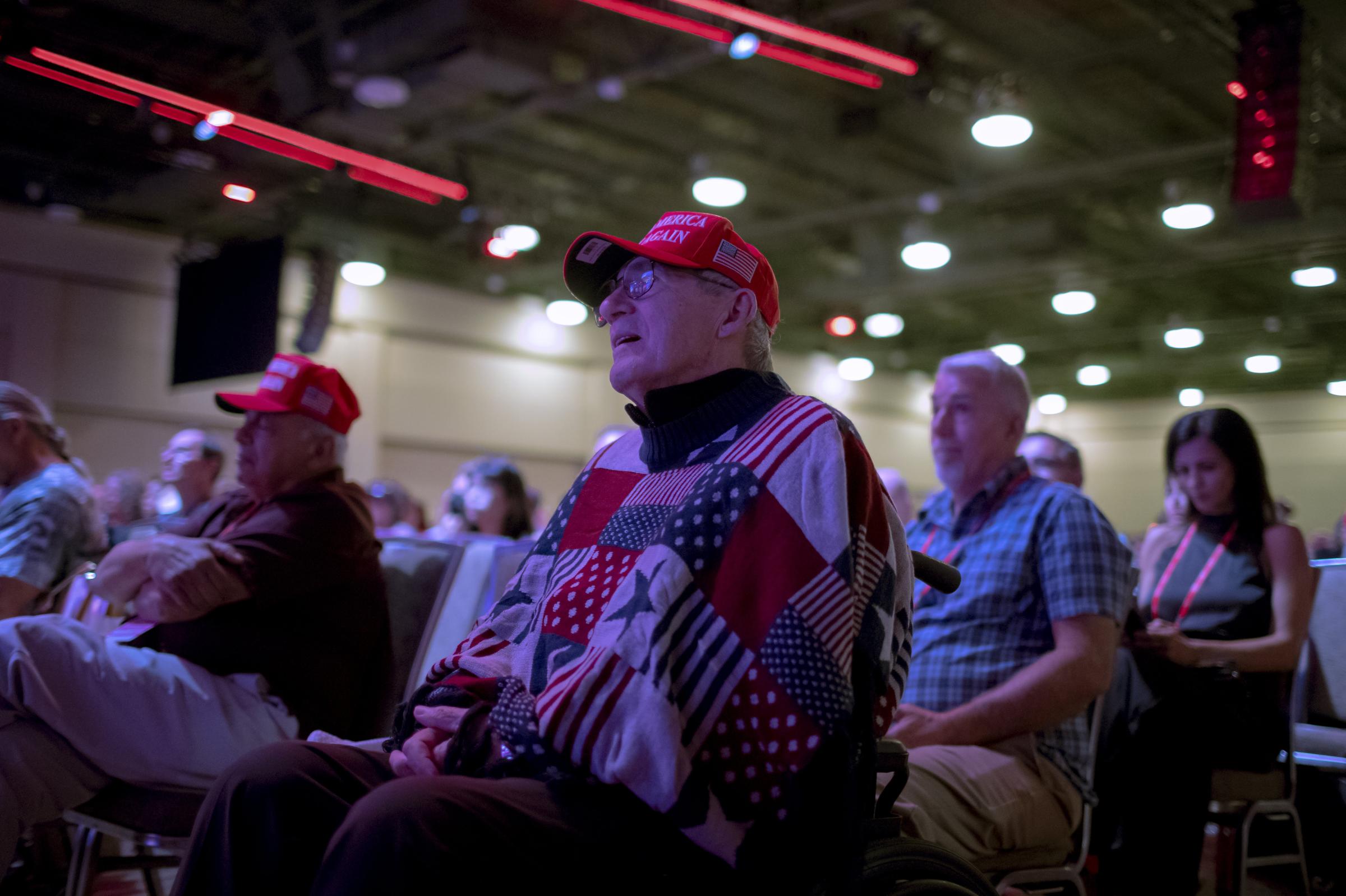 The Conservatives - A man in the crowd watches as Ken Buck, Speaks to CPAC...