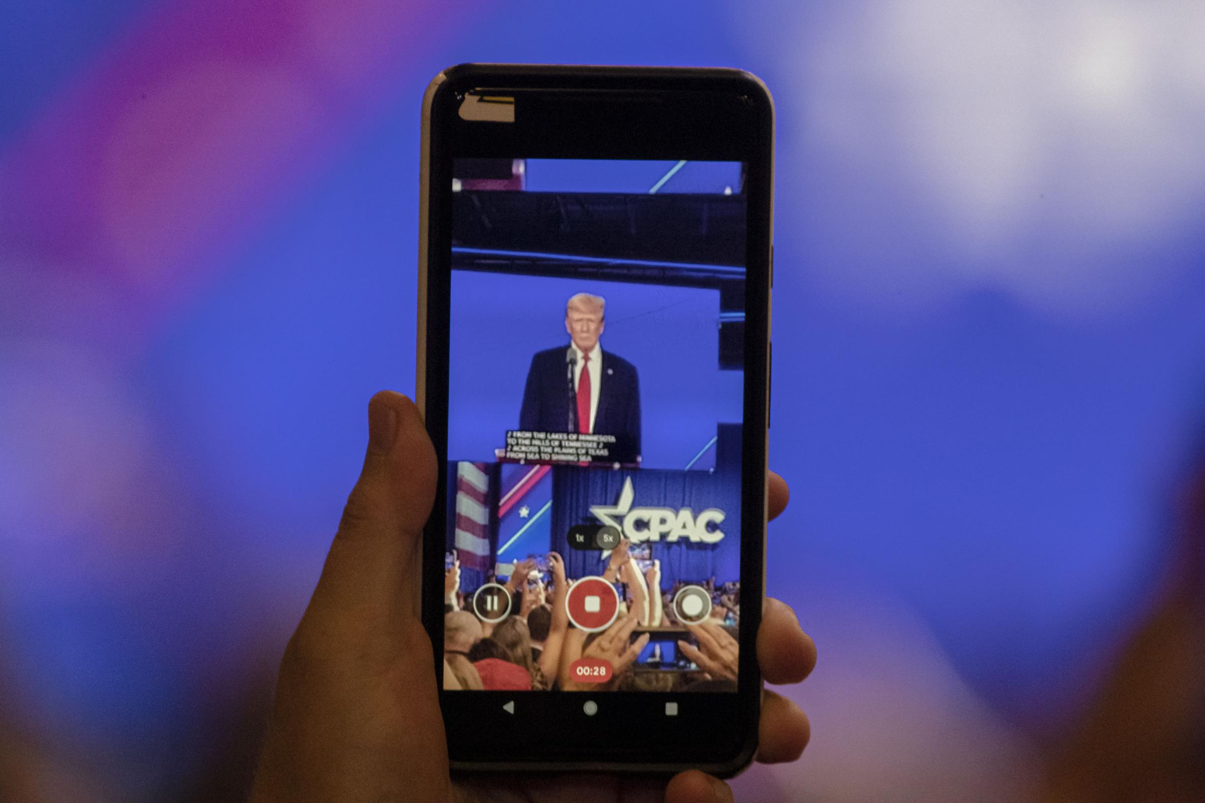 The Conservatives - Cellphones rise as Donald Trump makes his way to the...