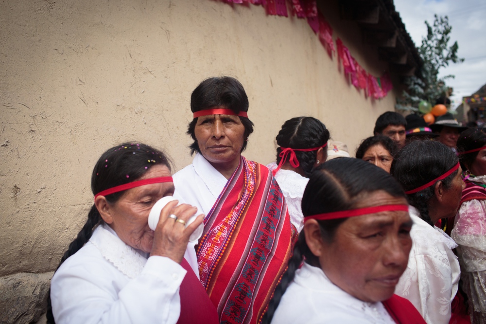 Chutanacuy!  -  Women from the red team drink chicha and cheer on their...