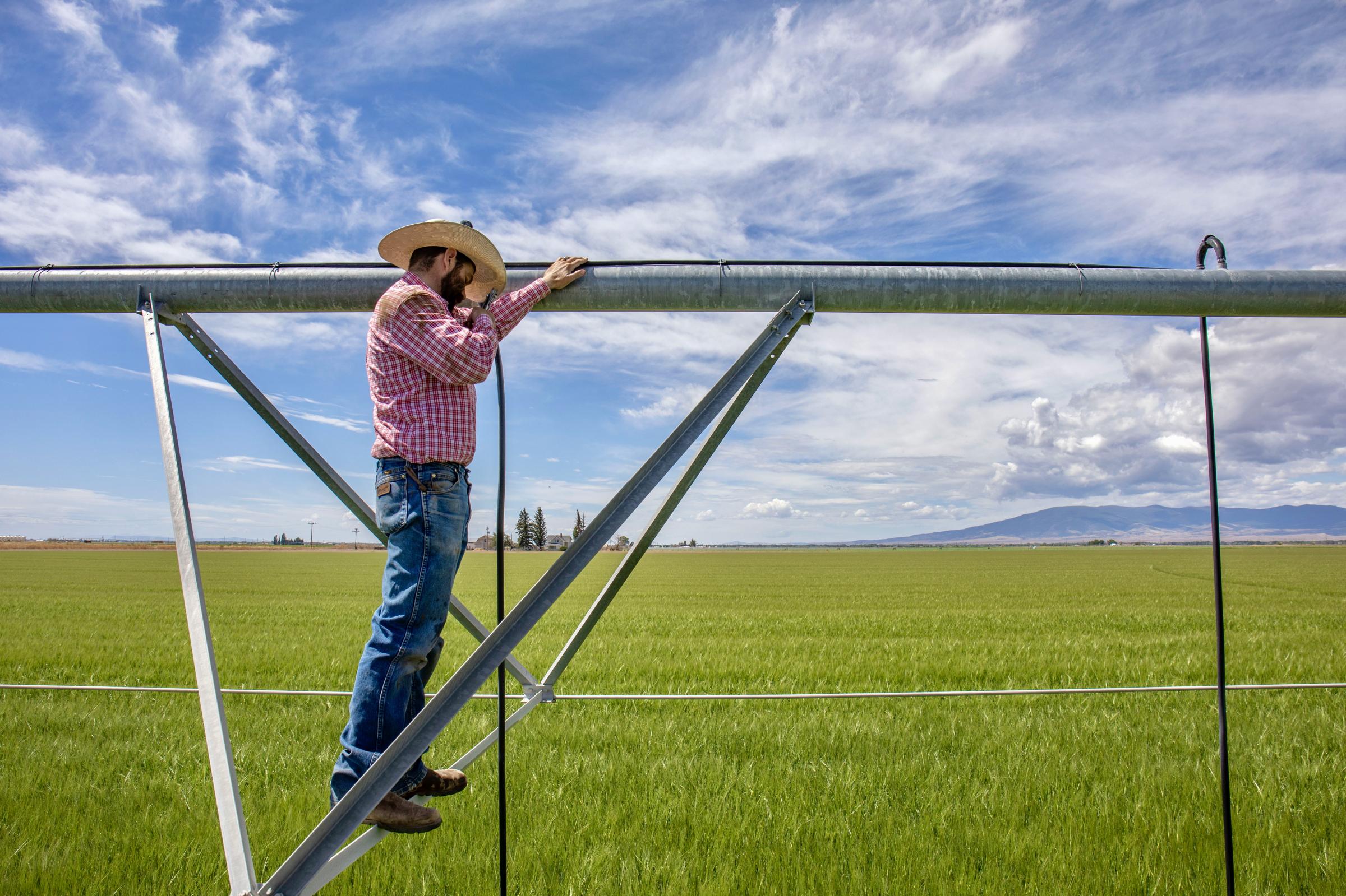 Crisis on the Rio Grande - Kyler Brown stands atop an irrigation sprinkler on the Monte Vista, Colorado property. (Photo by...