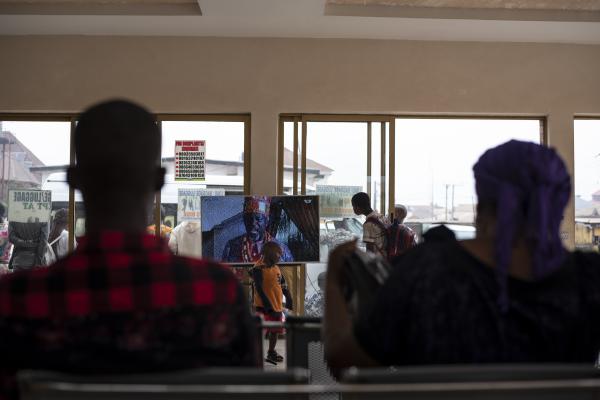 Unusual Niger Delta - Passengers watch a Nollywood movie at a bus park while...