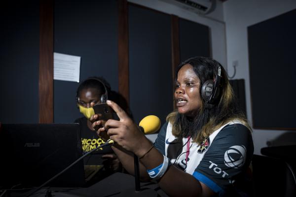 Image from Unusual Niger Delta - Tammy Uzodinma, a journalist reads a script for a radio...