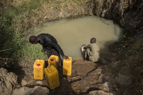 Mubarak collects water from the pond in Kinga community, Kwaja village, Adamawa. He also collects water for his neighbors that don&rsquo;t have access to a motorbike or are not physically fit.