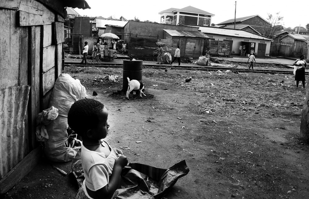  A CHILD LOOKS out onto the Namuwongo slum of Kampala City in Uganda. 