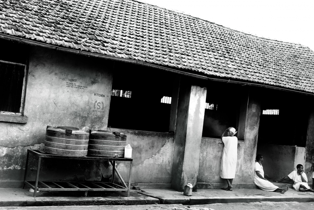  WOMEN PRISONERS outside the Gulu prison kitchen. Without any activities or schedule other than...
