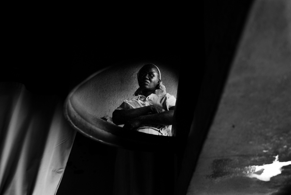  THE REFLECTION OF A WOMAN prisoner in a barrel of water. She lamented that being HIV+ she cannot...
