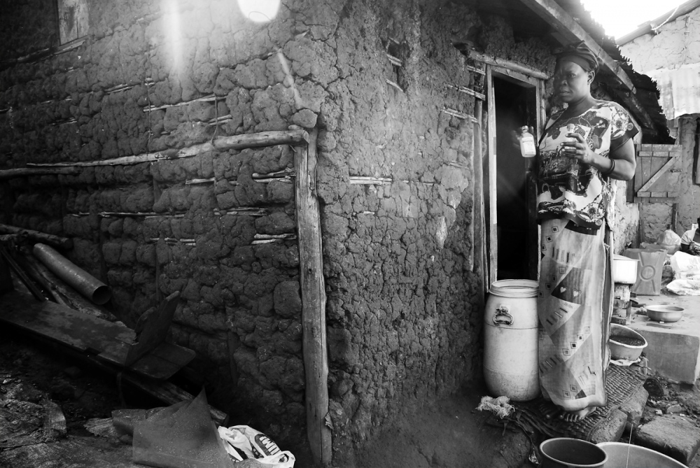 Uganda -  ALICE, A HOMEBREW GIN DISTILLER, at her home in the...