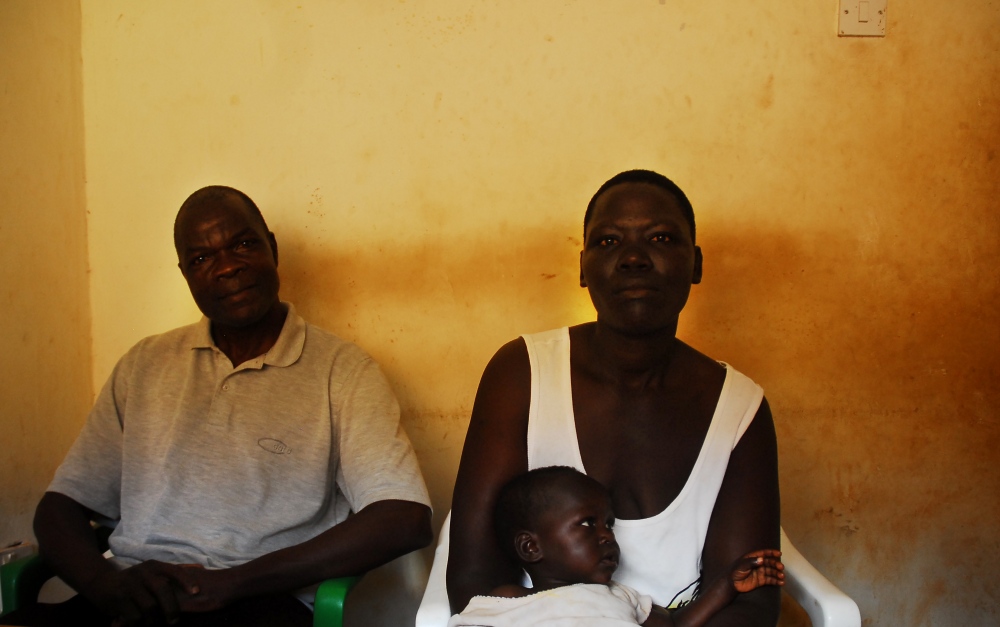 AIDS: Uganda -                    A family waits to receive HIV/AIDS...