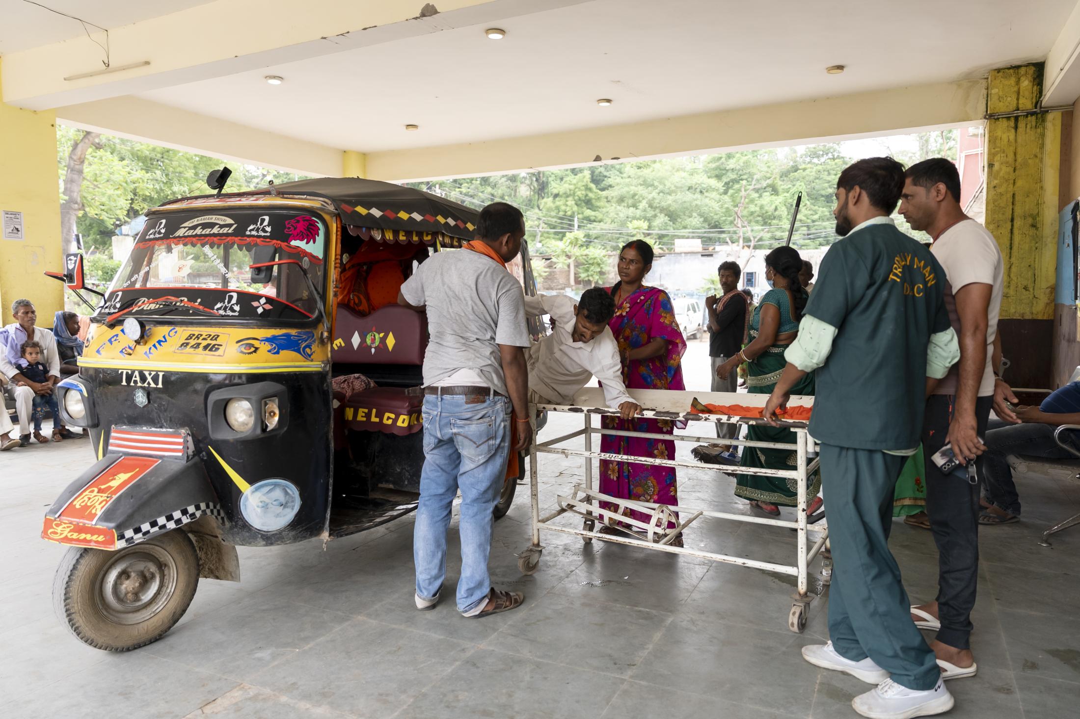 A man gets on to a stretcher at...l College and Hospital (ANMCH).