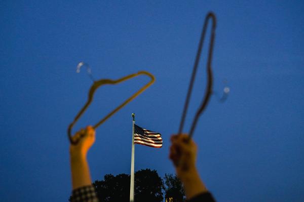 Image from Politics Singles -  Abortion rights advocates hold coat hangers, a symbol of...
