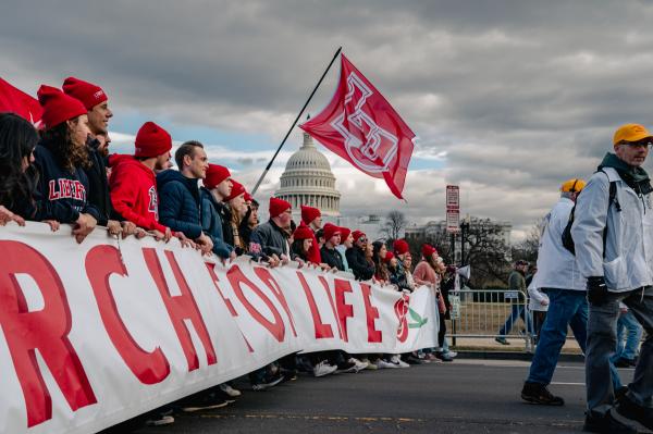 Image from Politics Singles -  Students with Liberty University lead the march during...