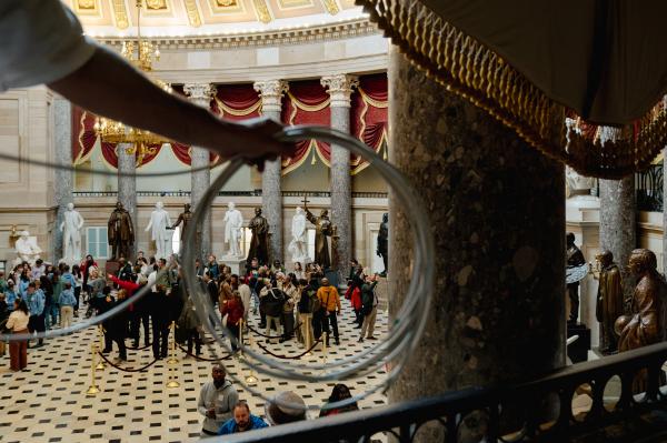 Image from The 2024 State of the Union Address -  Tourists wander through Statuary Hall as press crews...