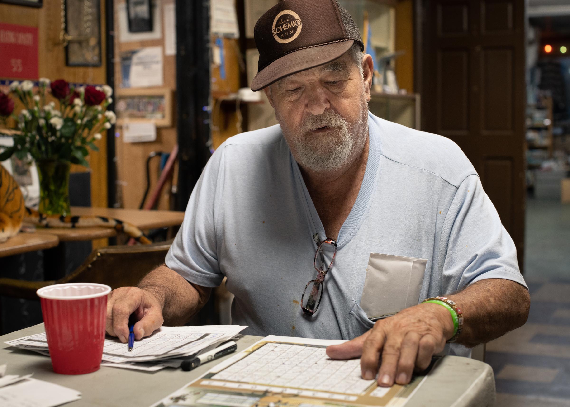 Post 67: American Legion, American Stories - Richard Izzi, the longtime post Commander, is meticulously reviewing the numerous super bowl bet...