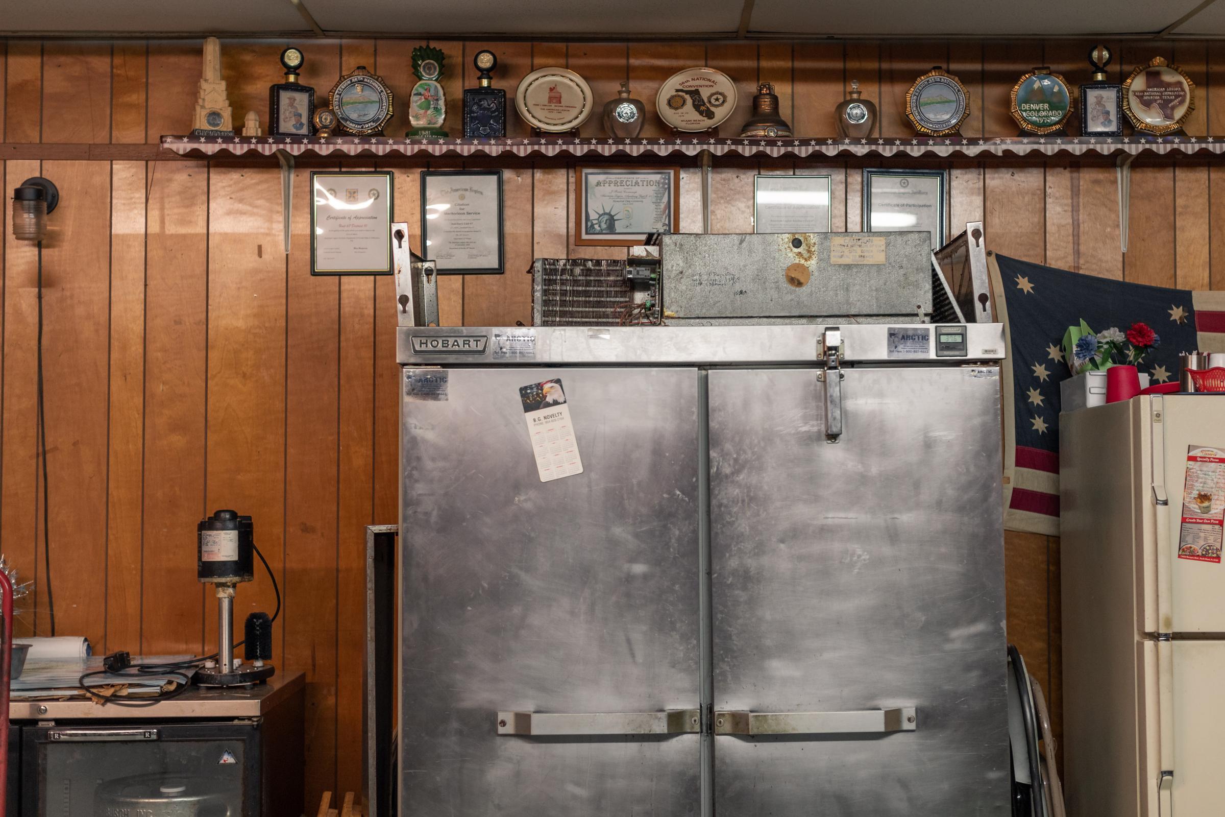 Post 67 - The dining hall at Post 67 is scattered with memorabilia. &nbsp;Potluck meals are an...