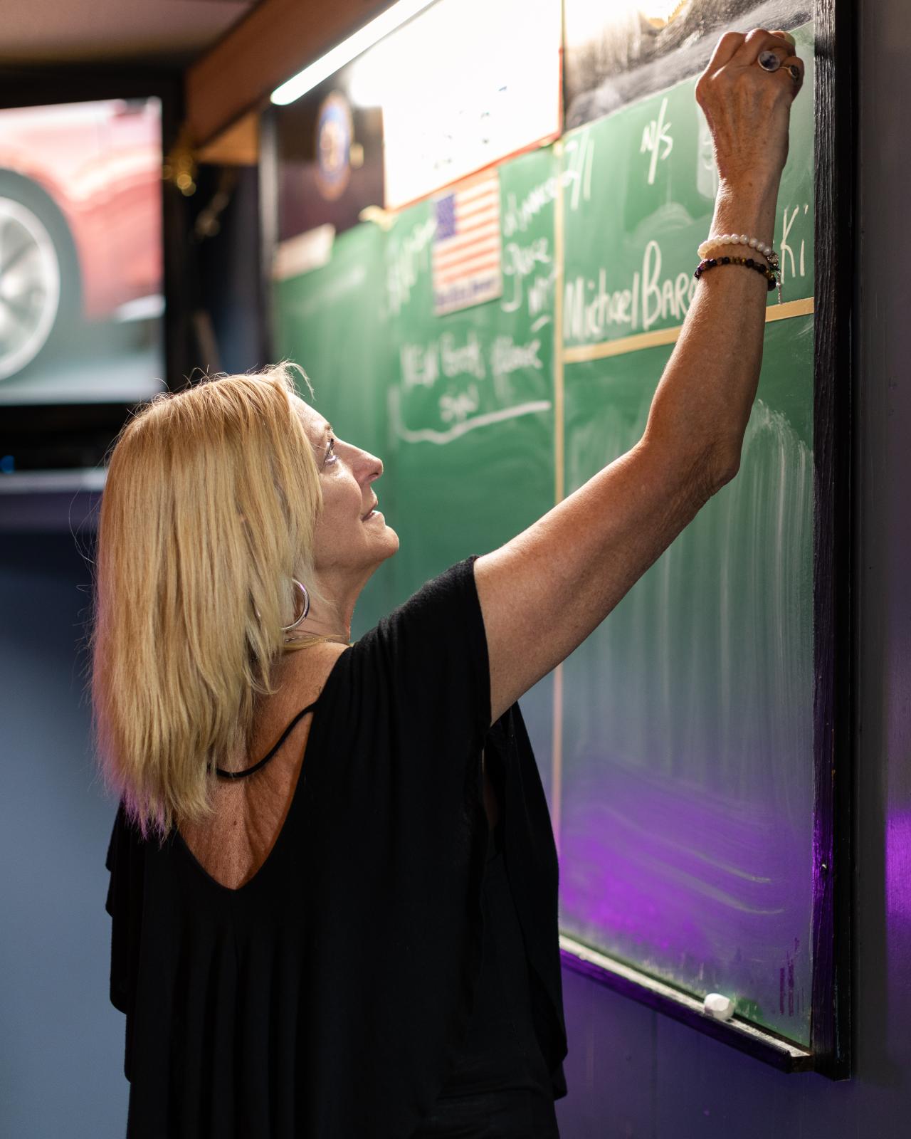 Post 67 - Donna Marchese, Post bartender updates information on the Post chalkboard. &nbsp;The...
