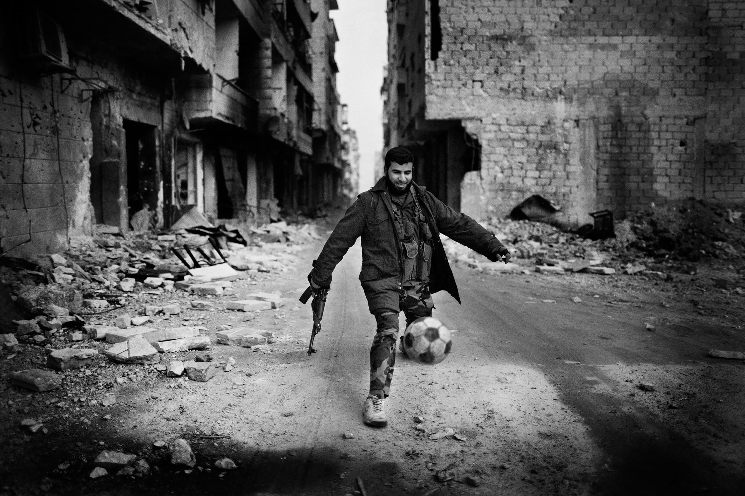 Alepo Scaring Frontlines - A Syrian islamist rebel plays football in the Al-Amriyah...