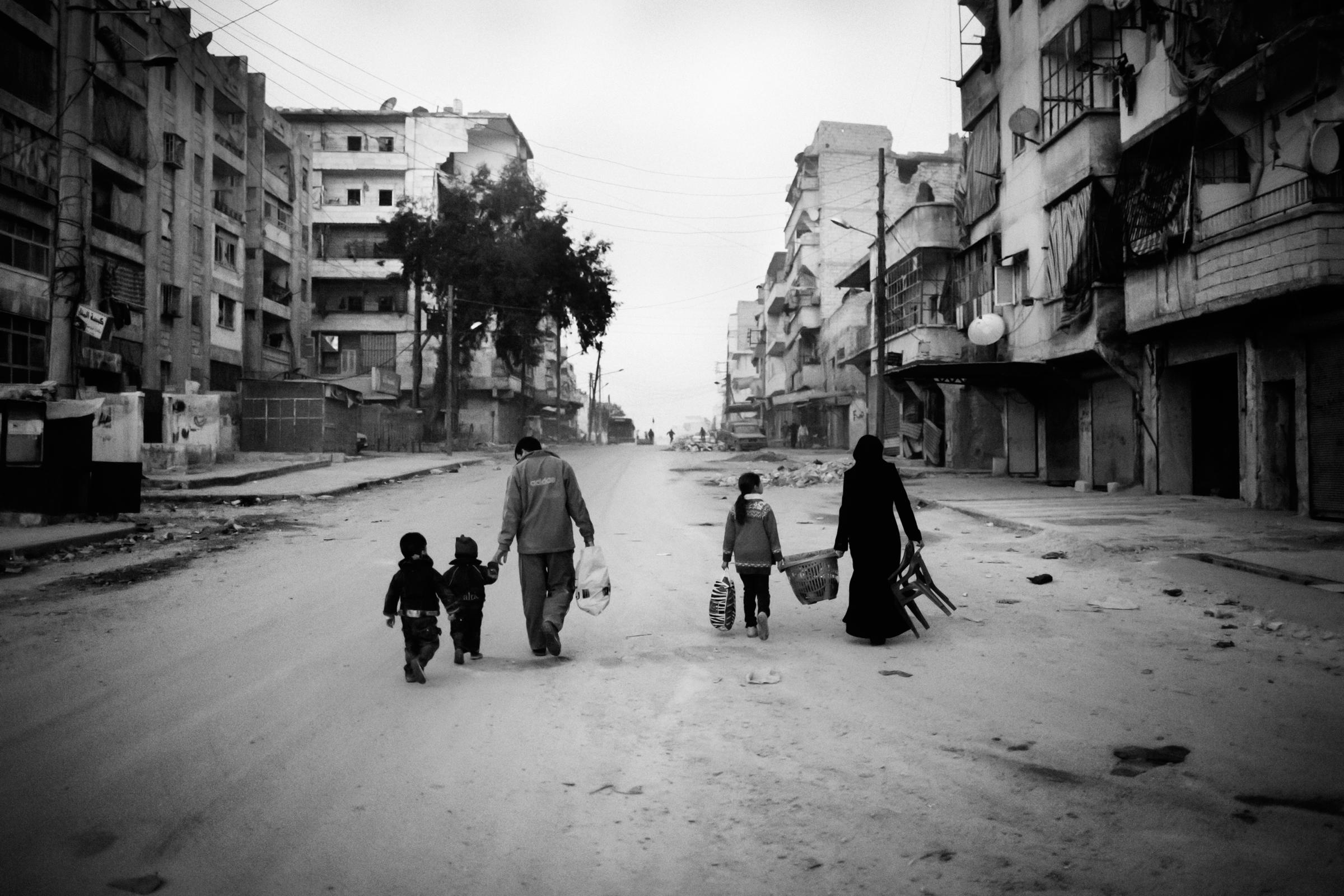 Alepo Scaring Frontlines - A family walking through the streets in the Al-Amriyah...