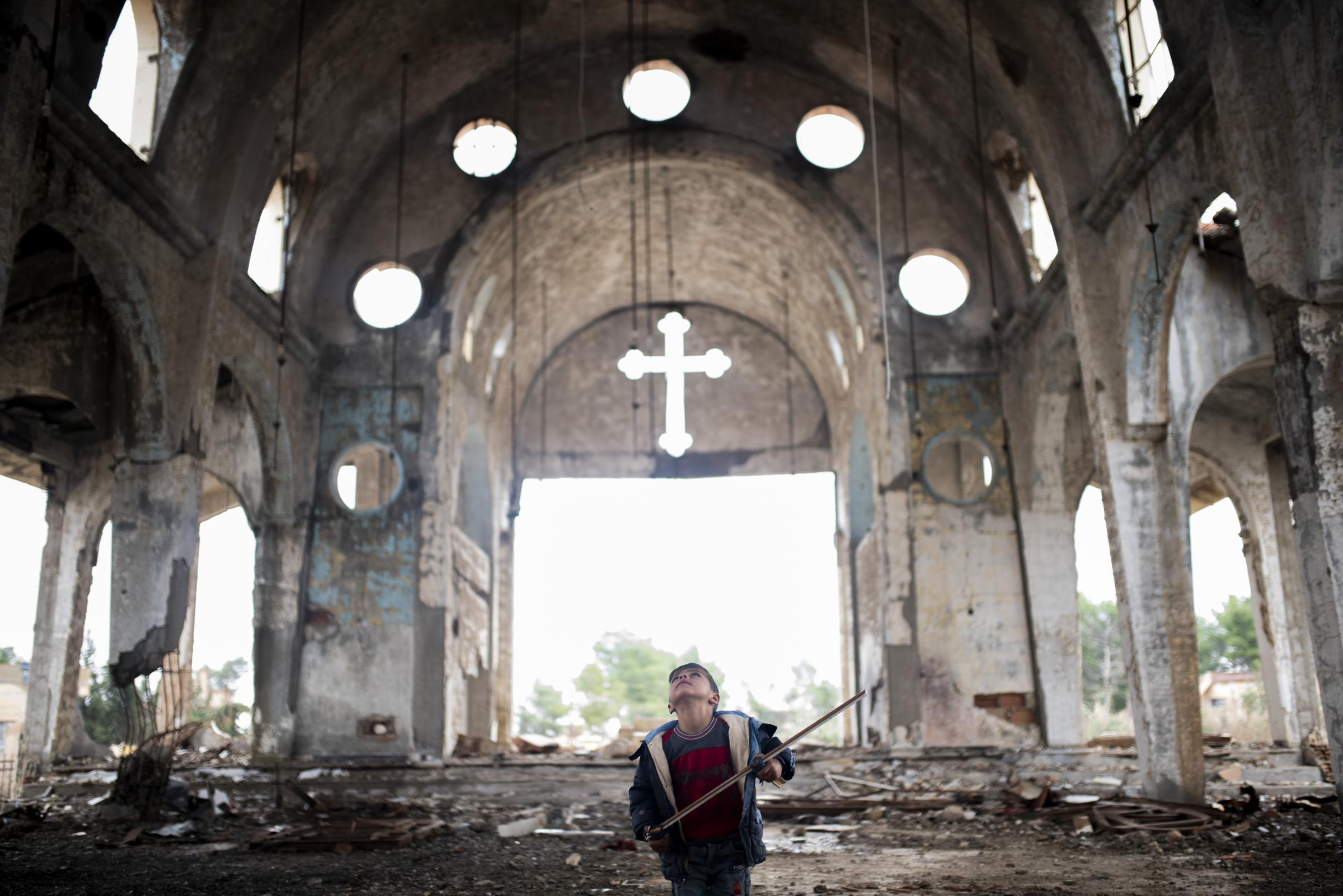 Mud Swings In Fire Fields - Child playing war games inside a destroyed church by ISIS...