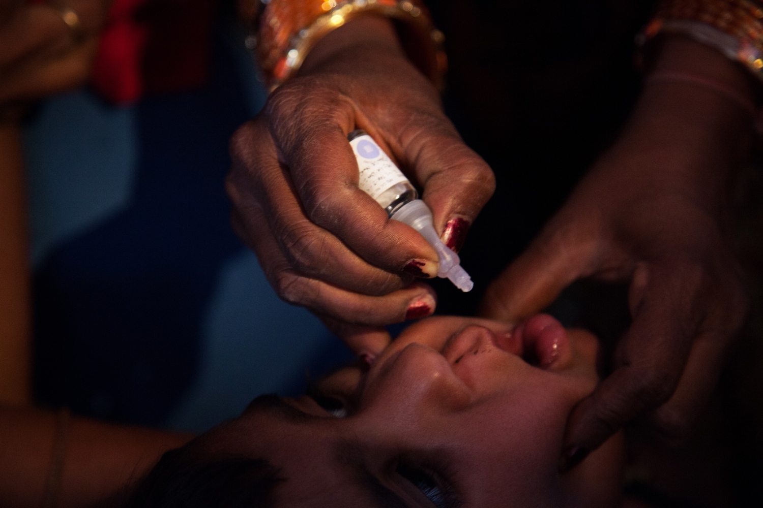 Keeping polio away -    A child being vaccinated for polio in Moradabad,...