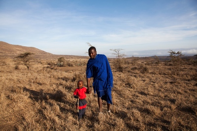    Paulo Papalay, 27, a Maasai warrior, with his 3-year-old son outside his home outside Mkuru, a sub-village in northern Tanzania.    