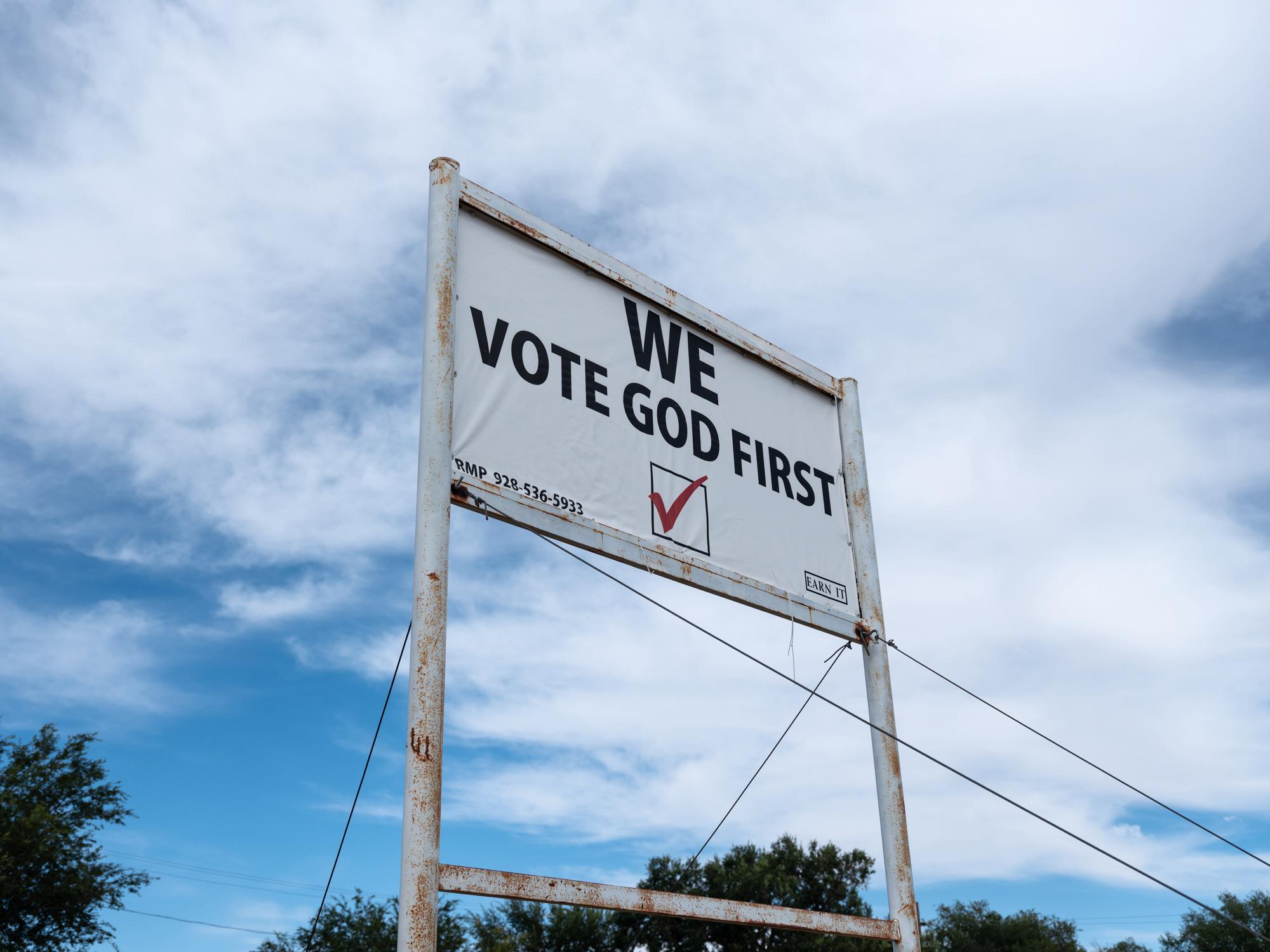 New Arizonans - HuffPost - A sign declaring “We Vote God First” sits...