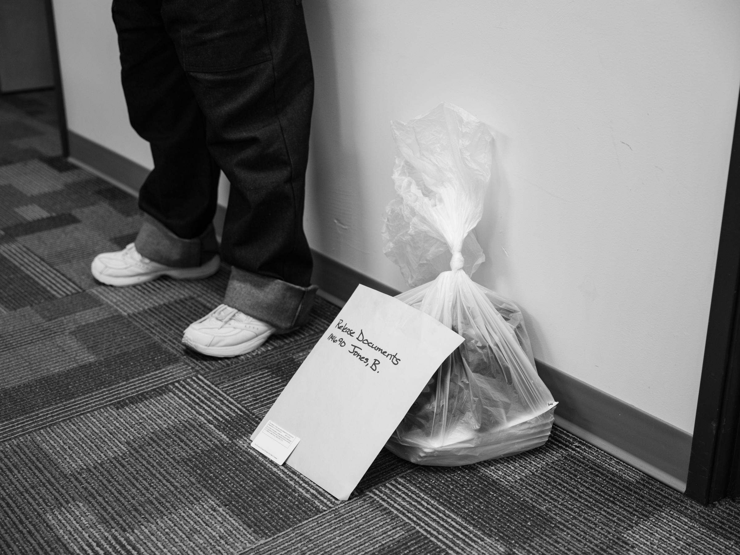 Barry Jones - The Intercept - Barry Jones stands next to his release documents and bag...