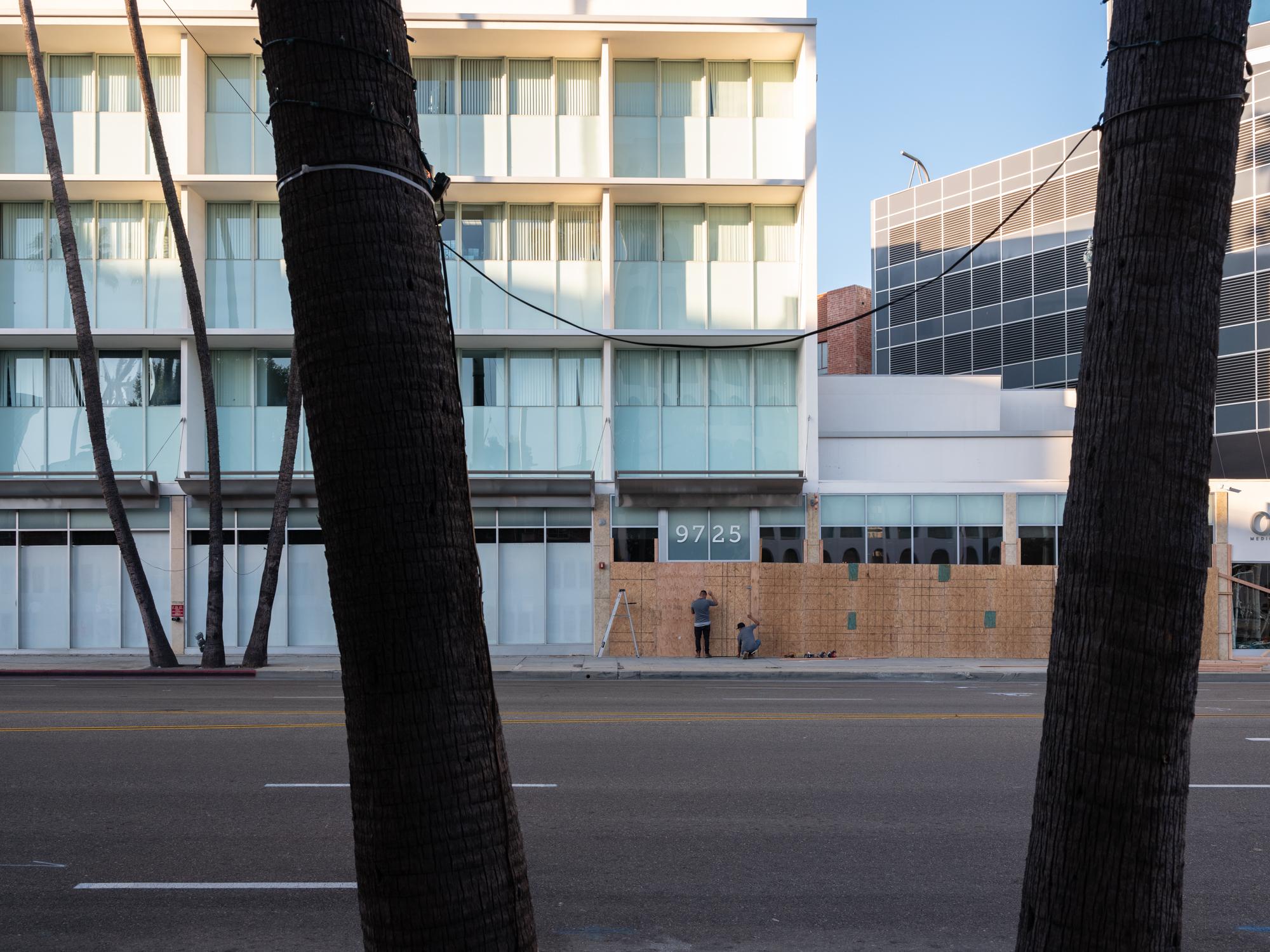 Politics + Protest - Workers board up buildings in downtown Beverly Hills in...