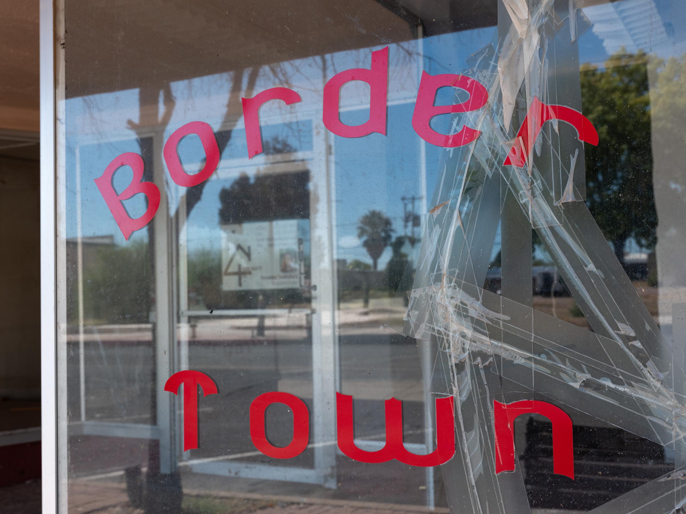 Social Media Migrant Smuggling - Bloomberg Businessweek - A shop window in the historic section of Douglas, AZ, on...