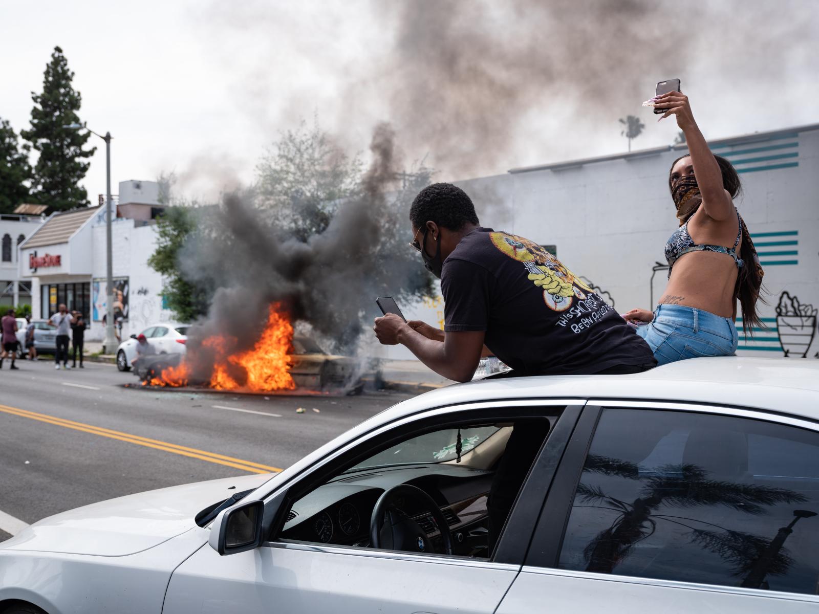 Selfies and a Burning Car | Buy this image