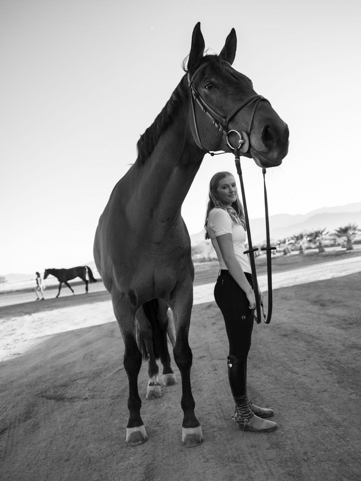 Maggie Kehring with her mother&#39;s horse, Agano, at the Desert International Horse Park. Now 19, Maggie is an equestrian who has competed internationally for the United States. She recounts being coerced into a relationship with her coach, Rich Fellers, after repeatedly saying no, when she was 16, and he was 60. Following a SafeSport investigation, Fellers was suspended from the sport. When SafeSport referred the case to the Oregon police, he was arrested on four counts of second-degree sexual abuse. The age of consent in Oregon is 18. His trial date is expected to be set in April 2022.