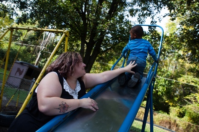    Erica Cortez, 33, a sex trafficking survivor in Columbus, Ohio, plays with her son Isaiah cortez, 3, in the park near the apartment they live in. Cortez was tattooed by her traffickers and got her tattoos covered thanks to a local grassroots project called Survivors Ink.     