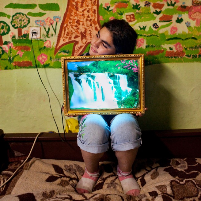 Madalina, 12, in her home where...esponsibilities at a young age.
