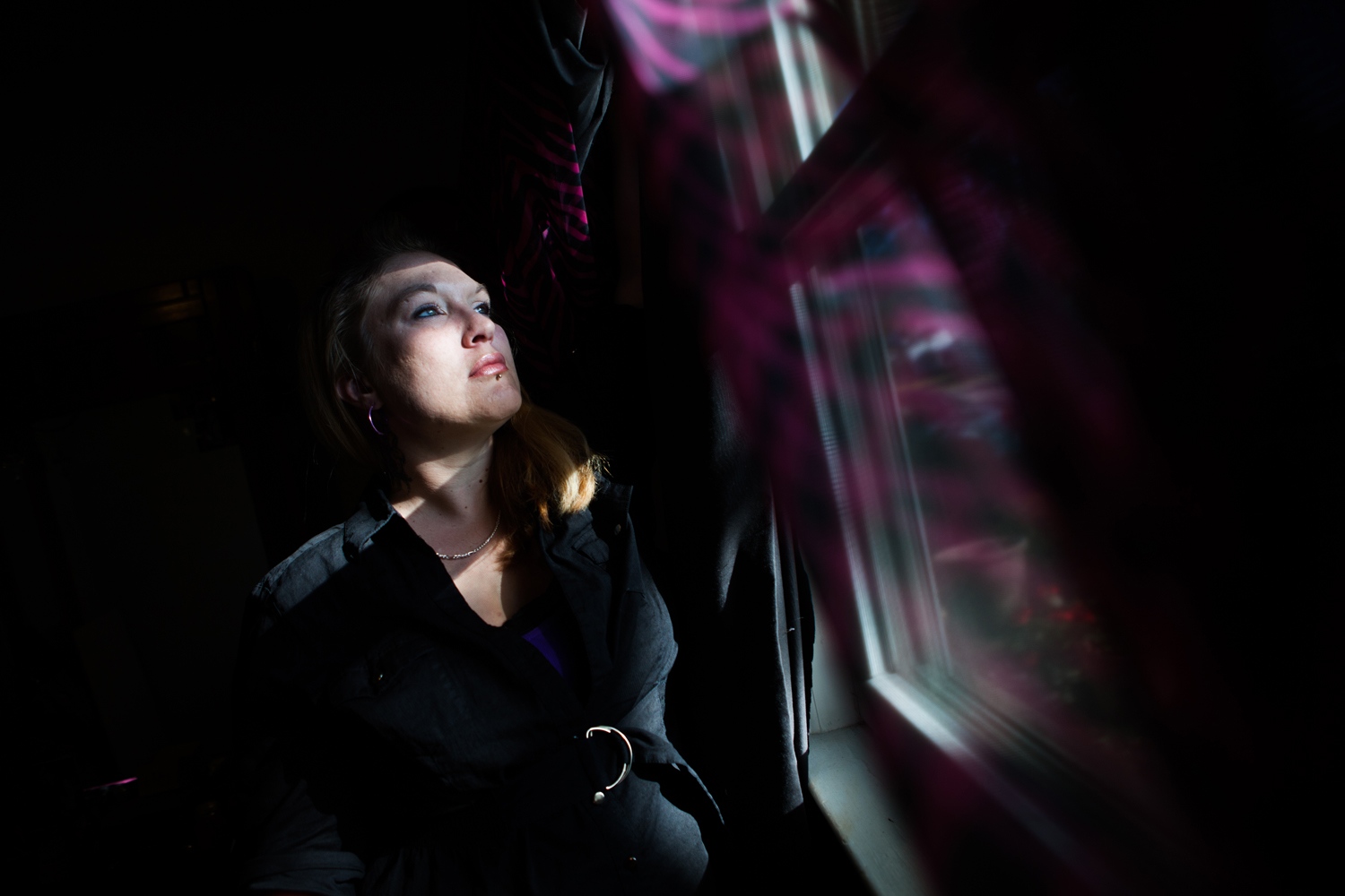 Survivors Ink -    Jennifer Kempton, 32, looks out her window in her...