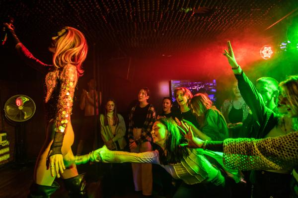 Image from Ukraine - Members of the audience reach for drag queen Adele at a...