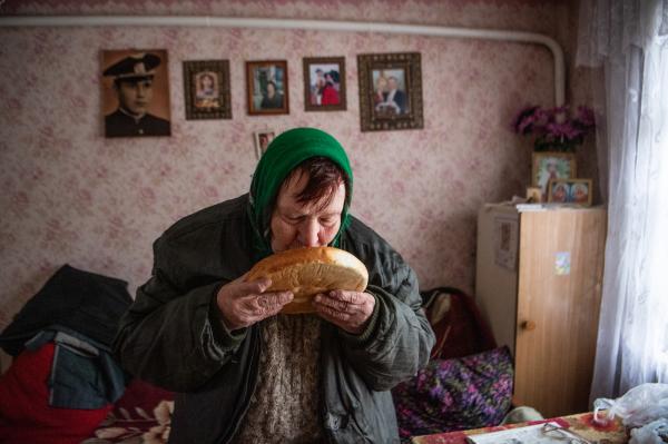 Image from Ukraine - A woman breathes in the scent of a fresh loaf of bread...