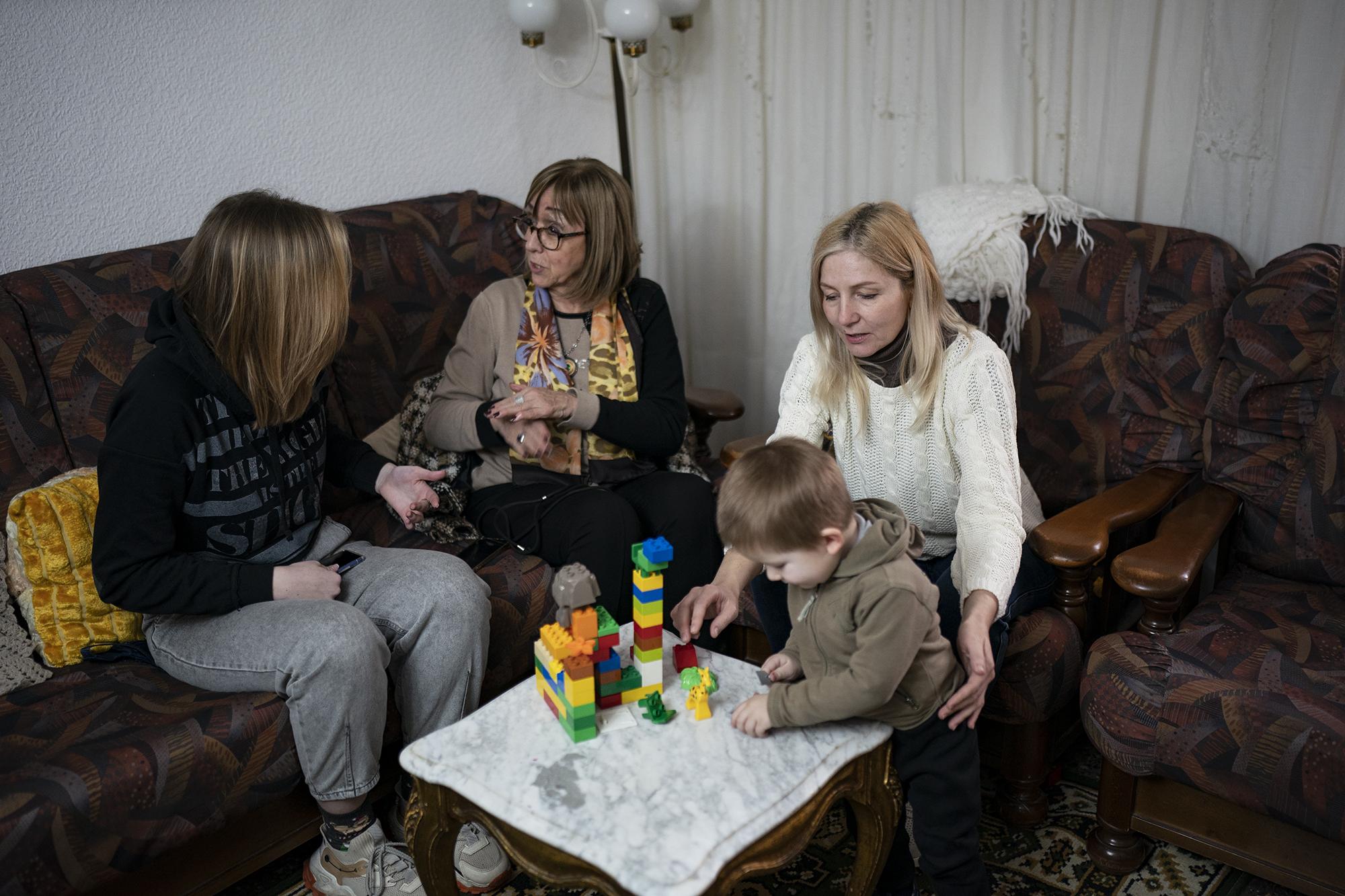 Ukrainian refugees sit in a home of a resident in the village of Guissona, Lleida, Spain, Thursday, March 17, 2022. (AP Photo/Joan Mateu Parra)