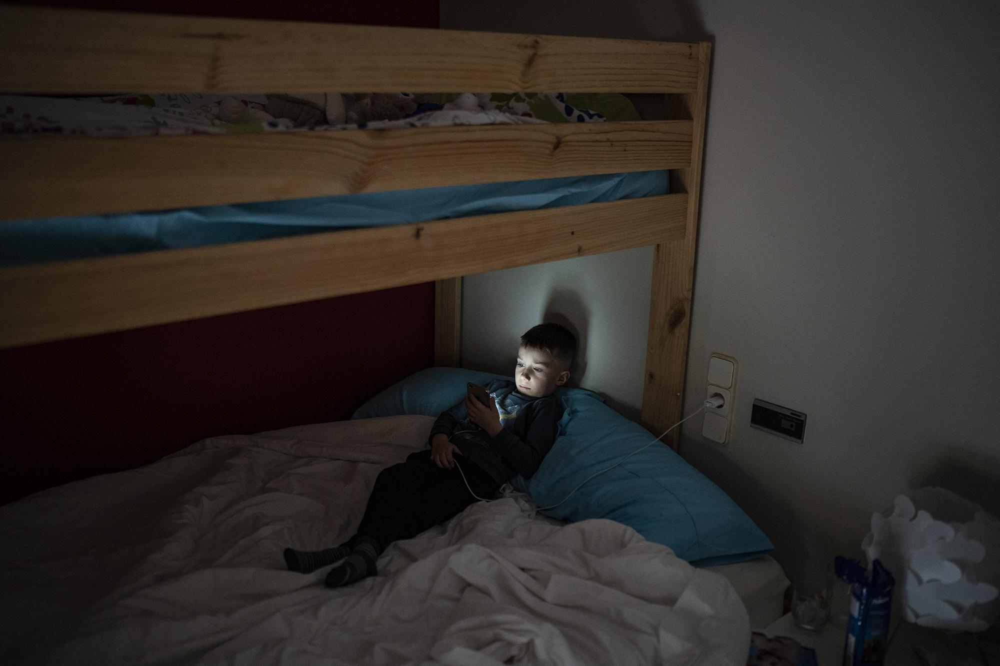 ''Little Ukraine'' Guissona - Maxym Batrak, 5, from Brovary, looks at a phone in a...