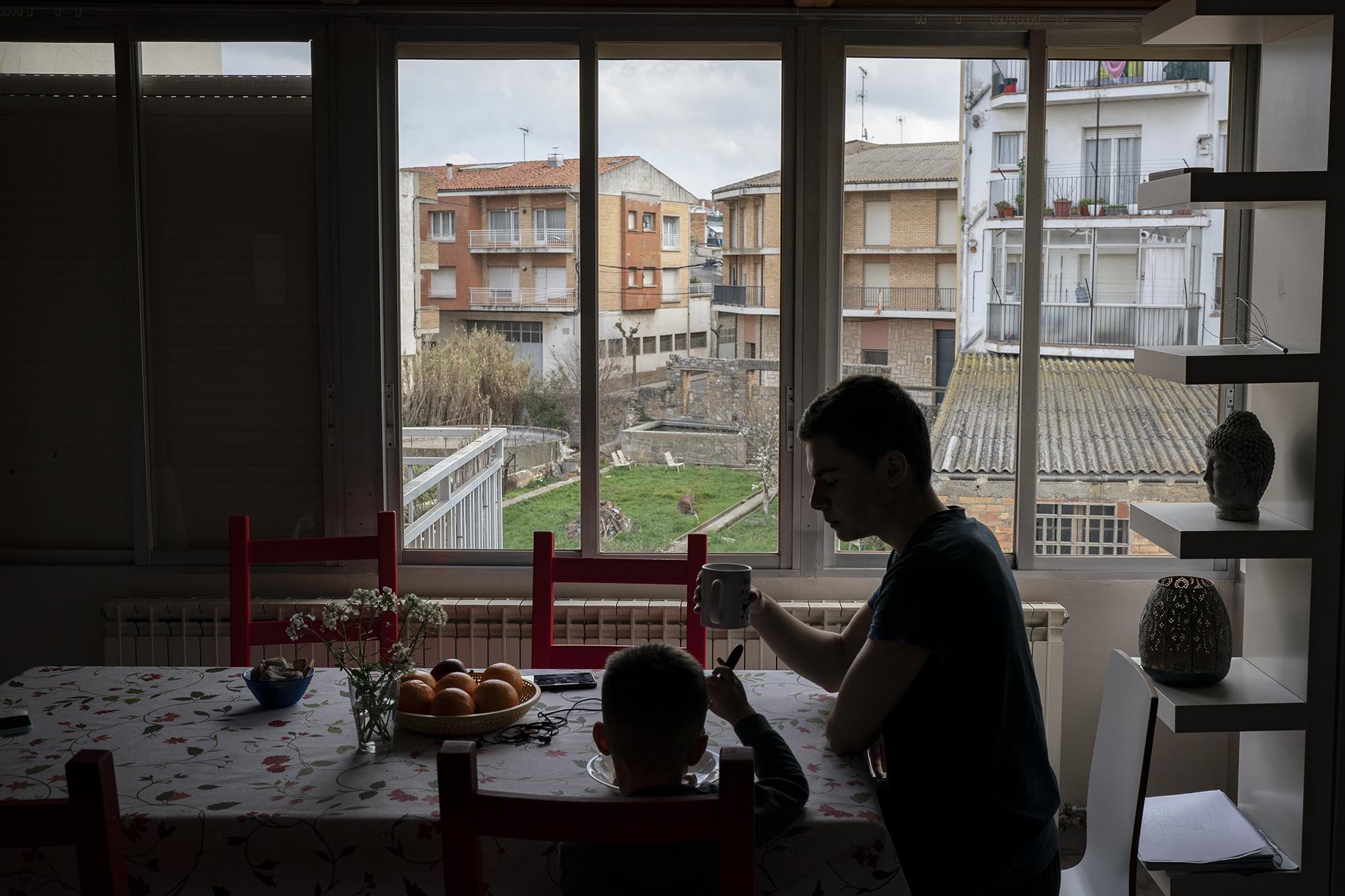 Maxym Batrak, 5, from Brovary and Max Slobodianiuk, 17, from Dnipro, have lunch in a house in the village of Guissona, Lleida, Spain, Tuesday, March 22, 2022. (AP Photo/Joan Mateu Parra)