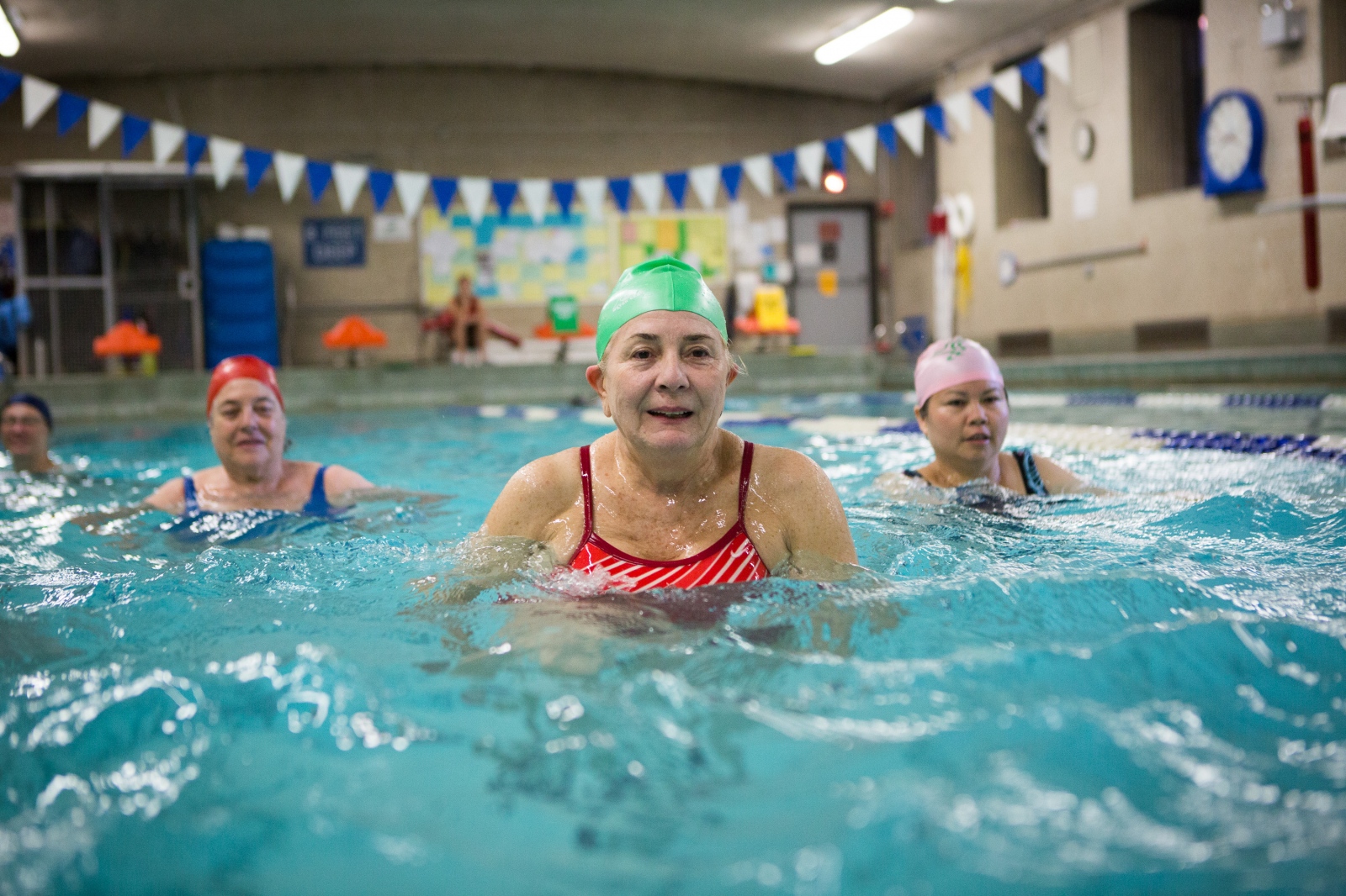 On the Spot, NYC -  Caridad Aguirre, center, smiles as she dances underwater...