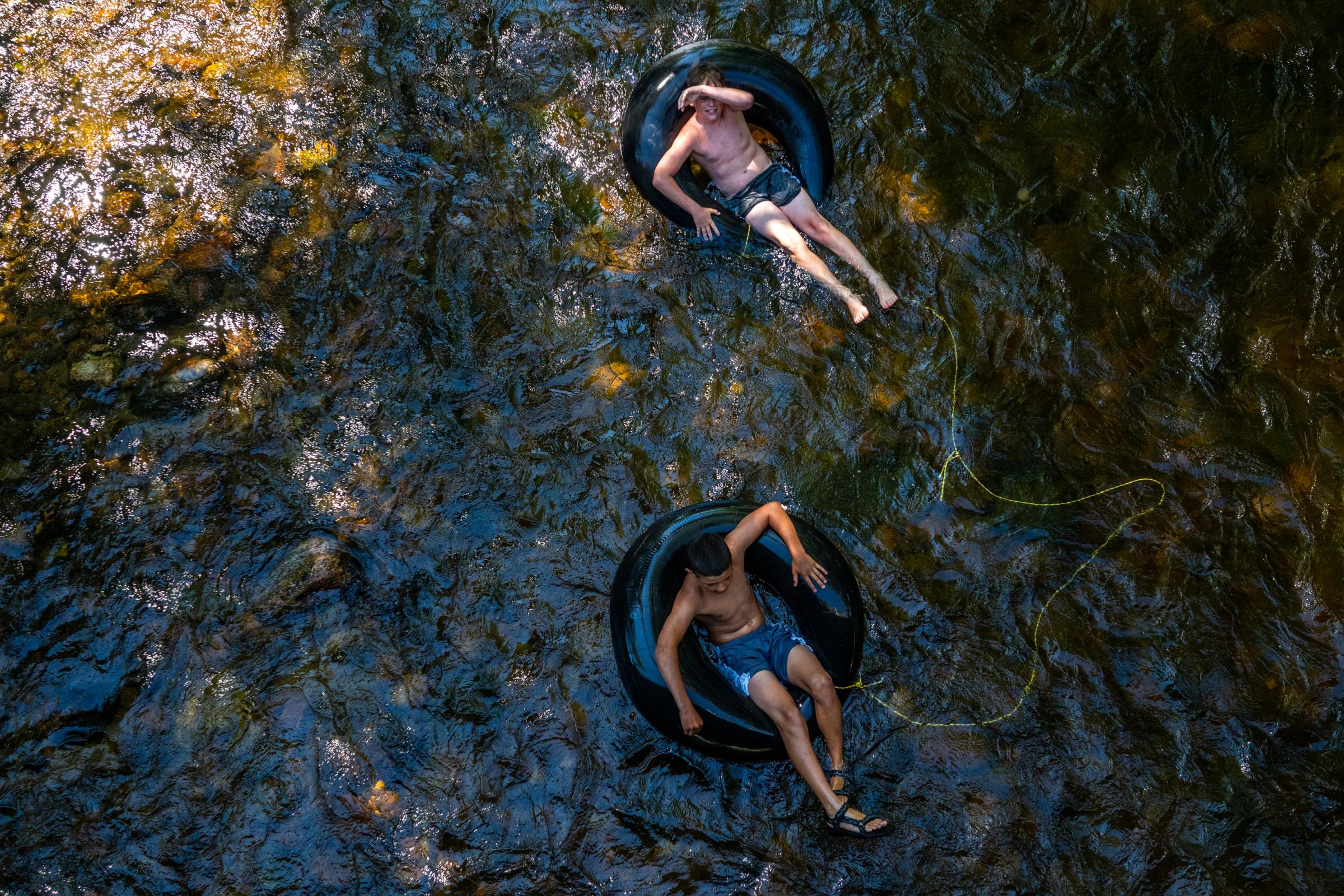 Singles - Easton Hill and Landon Fowler float down Clear Creek on...